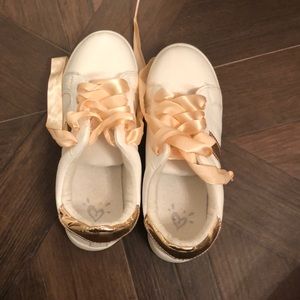 Girls gold sneakers with pink ribbons